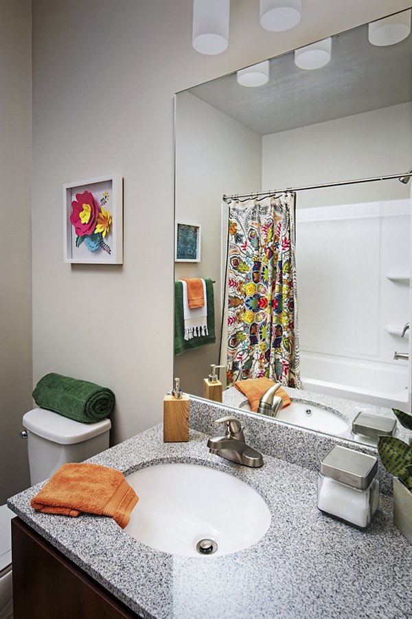 Bathroom featuring modern fixtures and elegant tilework at SkyVue Apartments