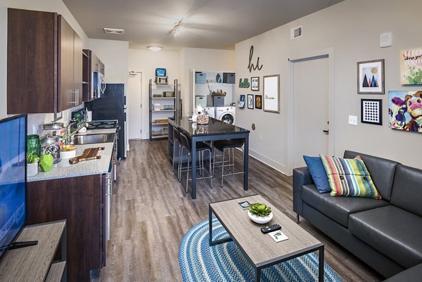 Dining room with modern decor and ample seating at SkyVue Apartments, featuring elegant lighting and stylish furnishings