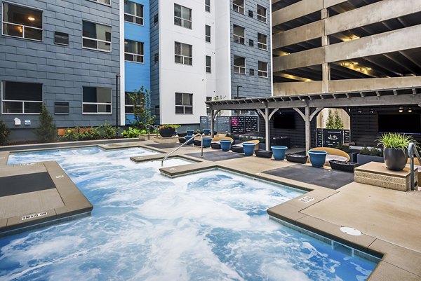 Rooftop pool with sun loungers and city views at SkyVue Apartments, perfect for relaxation and entertainment