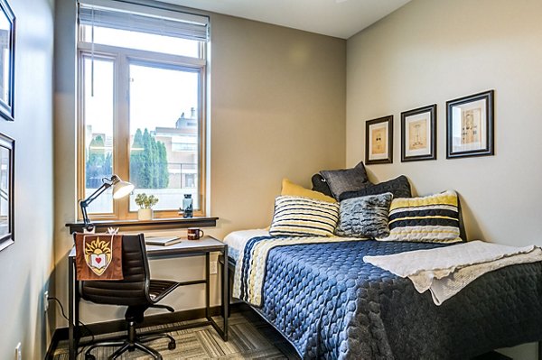 Cozy bedroom with modern design at Southside Commons Apartments, featuring elegant furnishings and natural light