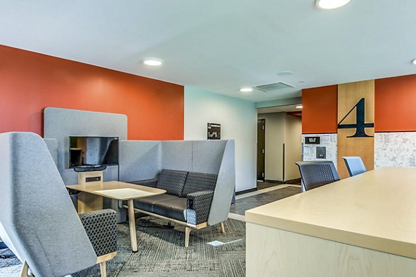 Clubhouse study area at Southside Commons Apartments featuring modern seating and study desks for collaborative work in cozy ambiance