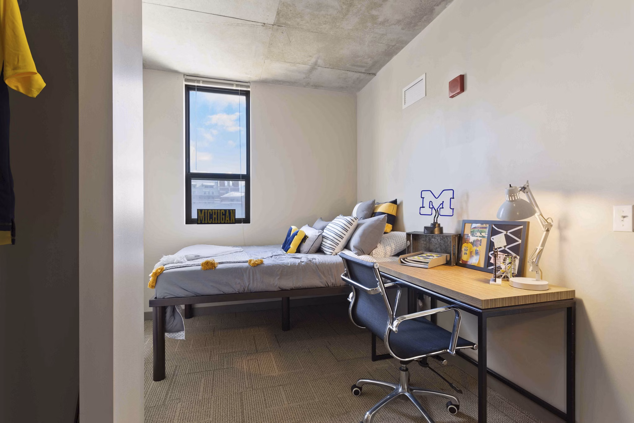 Modern bedroom featuring stylish dÃ©cor and large window in The Varsity Apartments