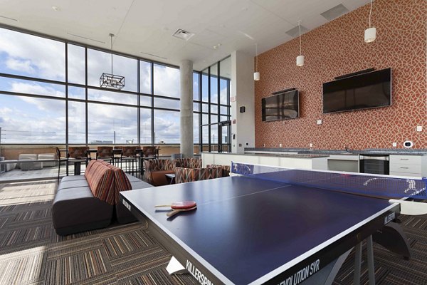 Game room with pool table and lounge area at The Varsity Apartments, luxury student housing near campus, designed for entertainment and relaxation