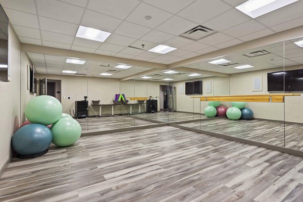 Yoga and spin studio with modern equipment at The Varsity Apartments, ideal for fitness enthusiasts seeking an active lifestyle
