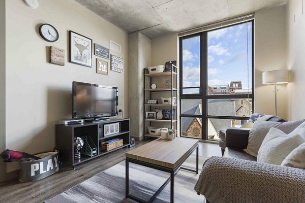 Modern living room with contemporary design at The Varsity Apartments, showcasing stylish furnishings and ample natural light