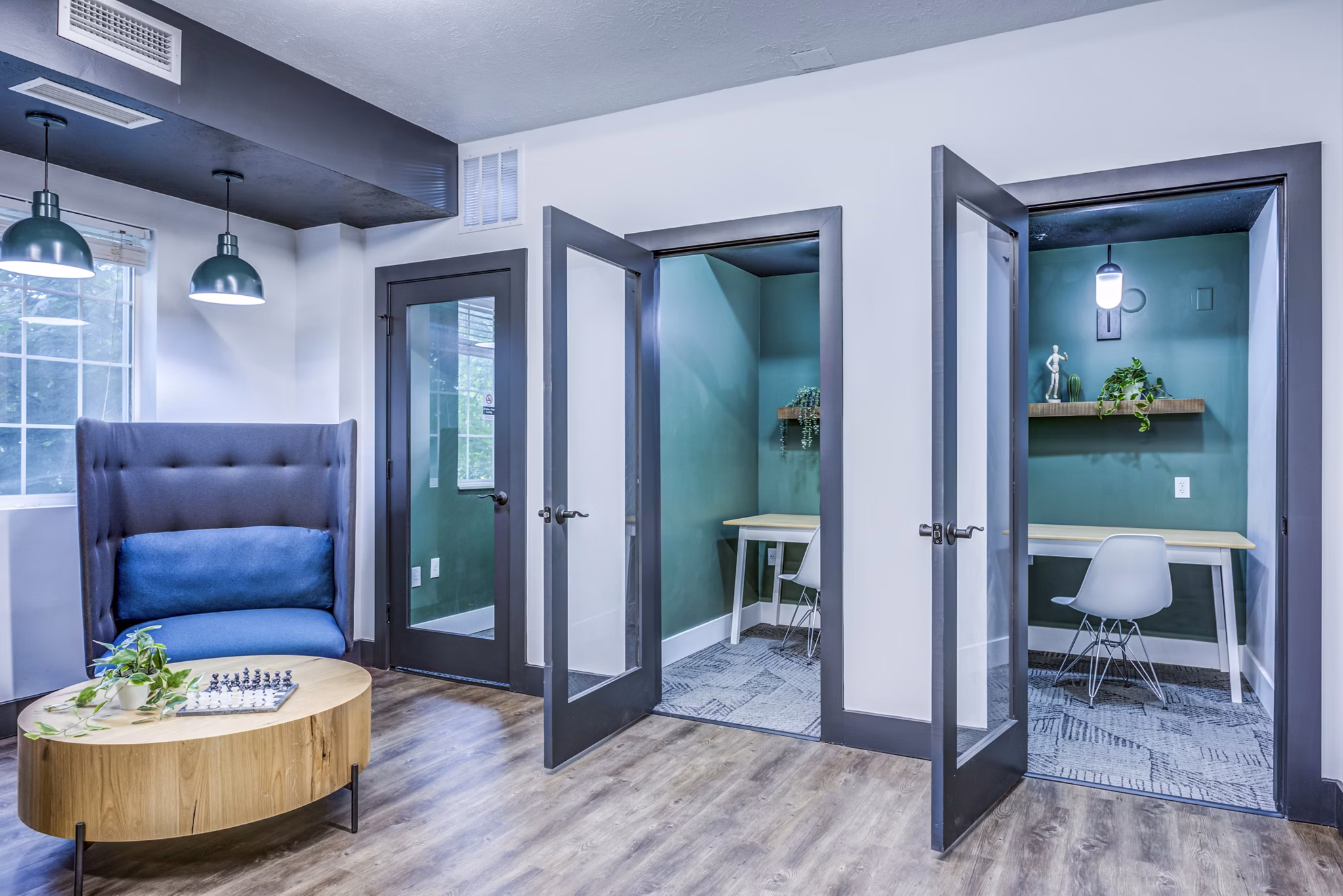 Clubhouse study area with modern workstations at Campus Village in E Lansing, an upscale community offering luxury apartments by Greystar
