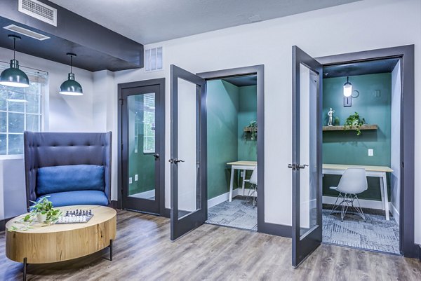 Clubhouse study area with modern workstations at Campus Village in E Lansing, an upscale community offering luxury apartments by Greystar