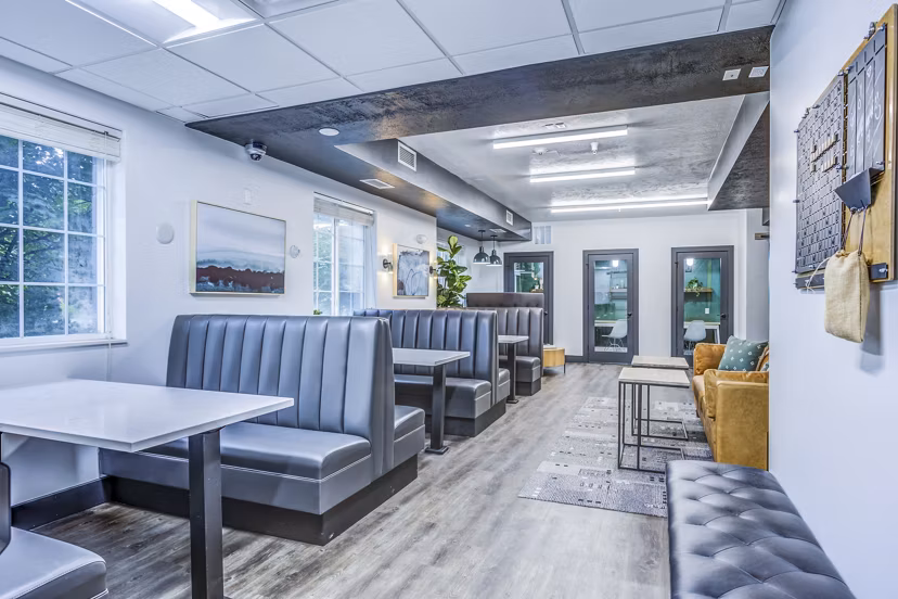 Clubhouse study area with modern design at Campus Village - E Lansing Apartments, ideal for focused study sessions in a luxury setting