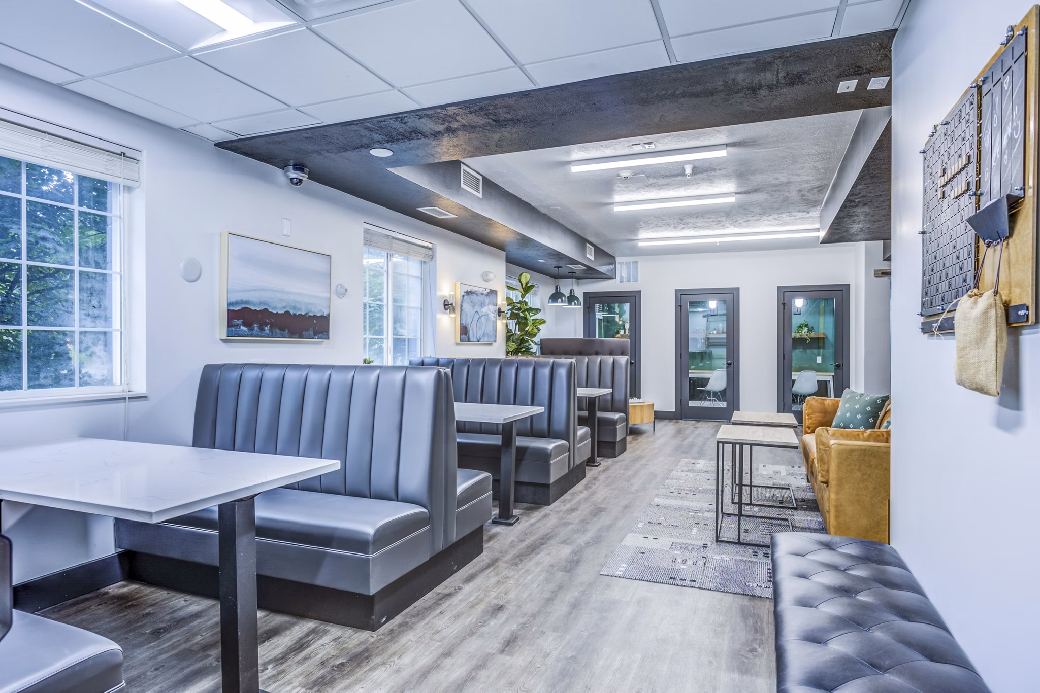 Clubhouse study area with modern design at Campus Village - E Lansing Apartments, ideal for focused study sessions in a luxury setting