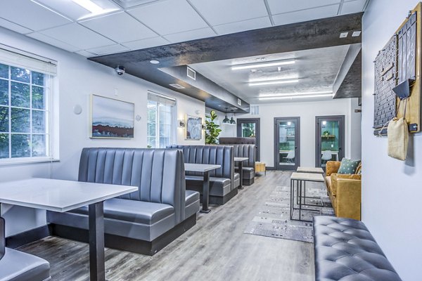 Clubhouse study area with modern design at Campus Village - E Lansing Apartments, ideal for focused study sessions in a luxury setting