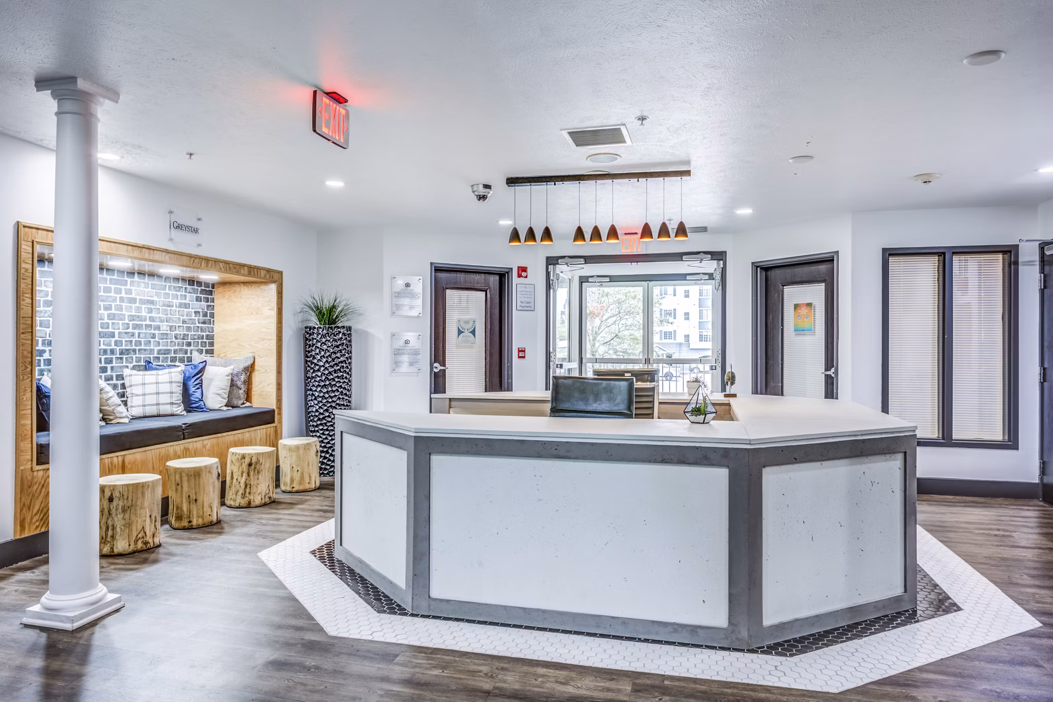 Spacious clubhouse lobby with modern seating at Campus Village - East Lansing Apartments