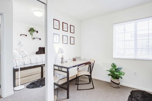 Dining area with modern decor and natural light at Campus Village apartments in East Lansing