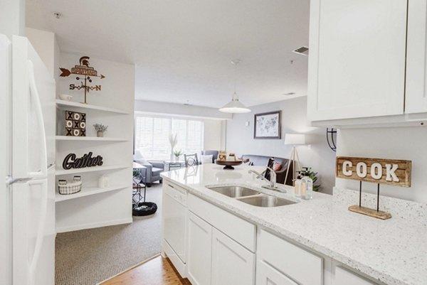 Modern kitchen with stainless steel appliances at Campus Village luxury apartments in East Lansing