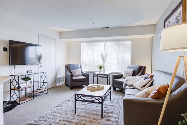 Cozy living room with modern furnishings at Campus Village, East Lansing, luxury apartments