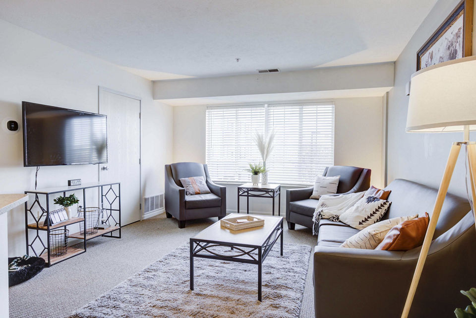 Cozy living room with modern furnishings at Campus Village, East Lansing, luxury apartments