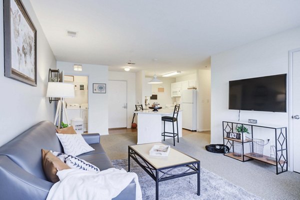 Spacious living room with modern furnishings in Campus Village, East Lansing