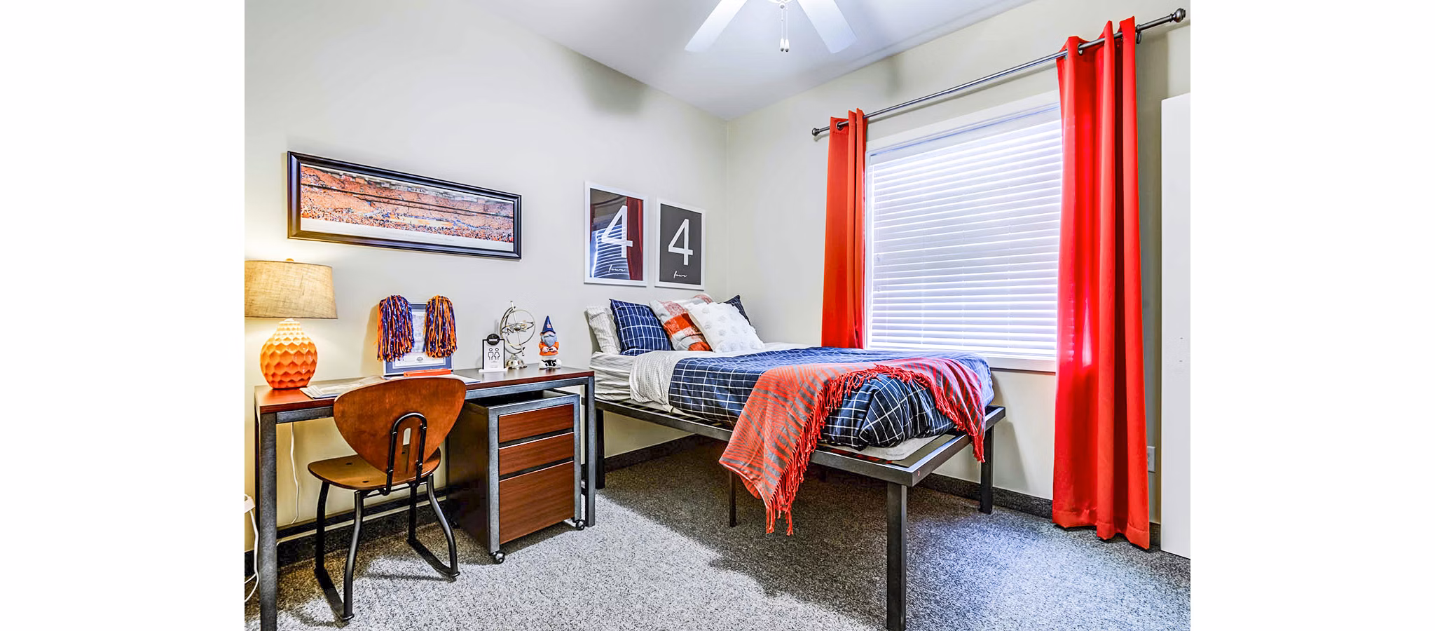 Bedroom with modern furnishings at University Village Apartments On Colvin, a luxury property managed by Greystar
