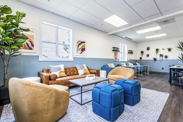 Clubhouse at University Village Apartments: Modern communal space featuring seating and entertainment areas at luxury property on Colvin