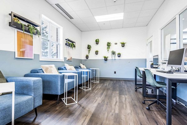 Clubhouse featuring modern design and comfortable seating at University Village Apartments on Colvin