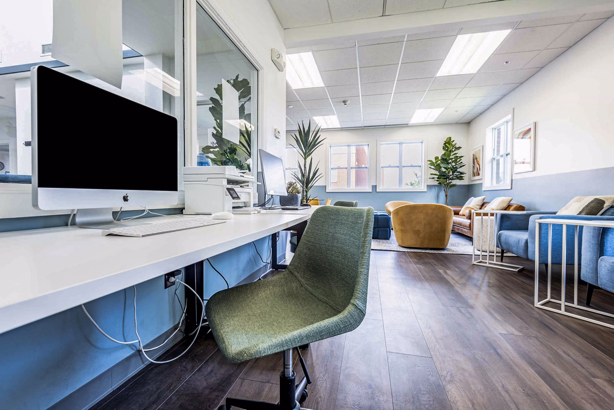Clubhouse business center with modern workstations at University Village Apartments On Colvin, offering a productive environment for luxury living