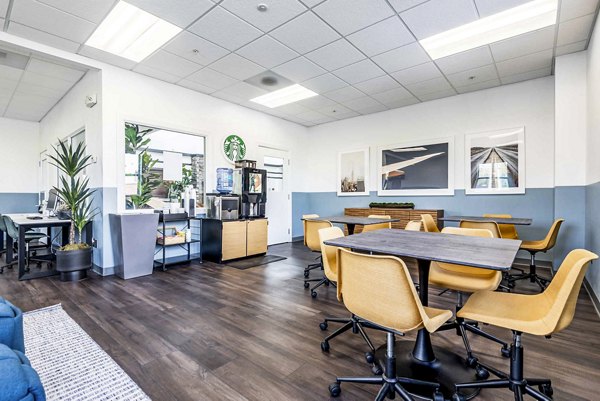 Clubhouse featuring modern design and ample seating at University Village Apartments on Colvin