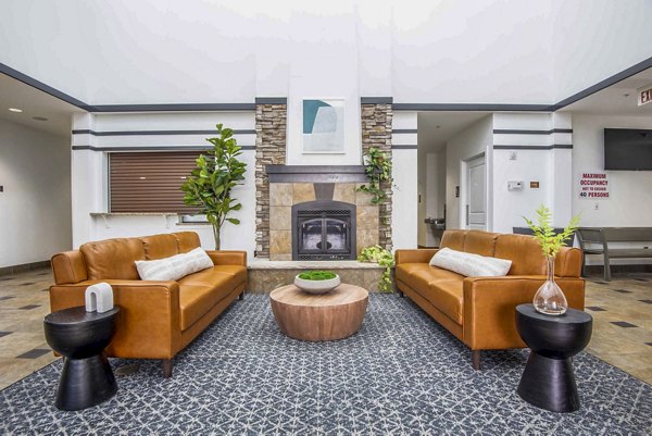 Modern clubhouse featuring lounge seating and billiards at University Village Apartments on Colvin