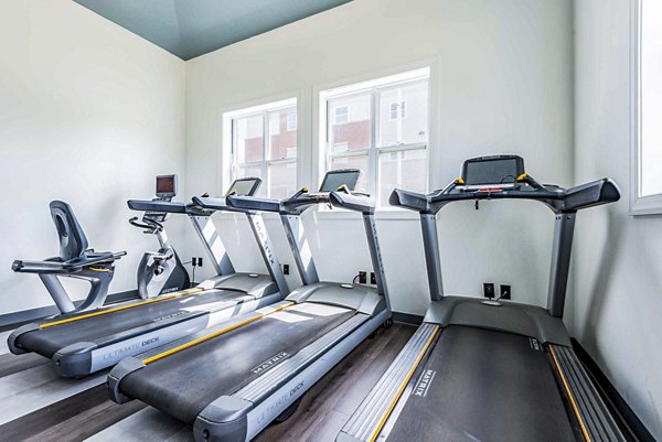Fitness center with state-of-the-art equipment at University Village Apartments on Colvin, offering wellness amenities for residents
