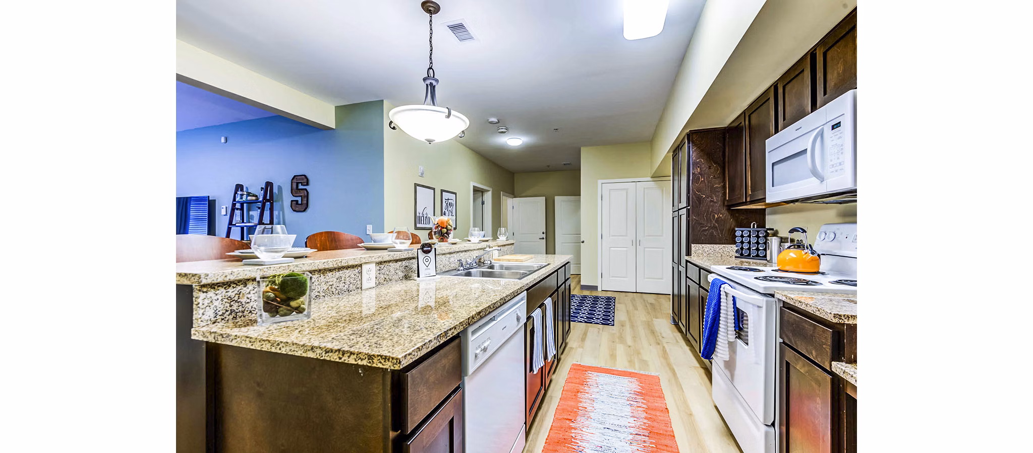 Modern kitchen featuring stainless steel appliances at University Village Apartments on Colvin