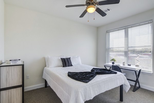 Spacious bedroom with modern decor at The Oaks on The Square Apartments