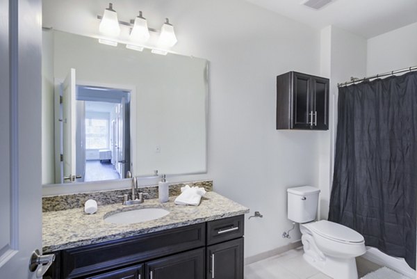 Bathroom with sleek marble countertops and modern fixtures at The Oaks on The Square Apartments, exemplifying luxury living