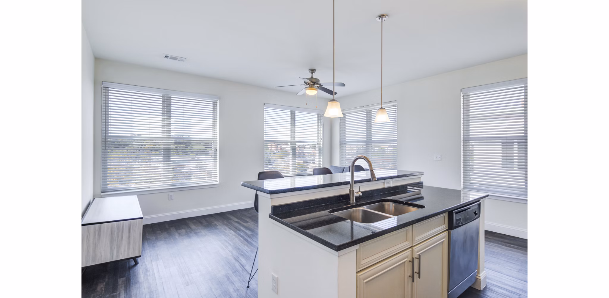 Modern kitchen with stainless steel appliances at The Oaks on The Square Apartments Luxury interior design in an upscale living space