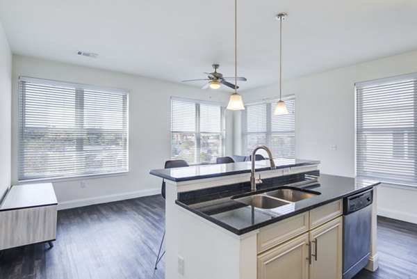 Modern kitchen with stainless steel appliances at The Oaks on The Square Apartments Luxury interior design in an upscale living space