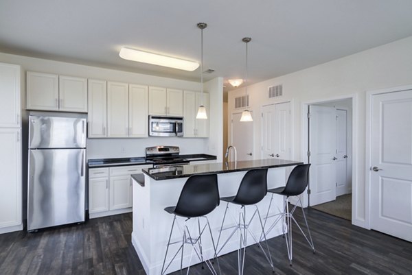 The Oaks on the Square Apartments: Modern kitchen with granite countertops and stainless steel appliances