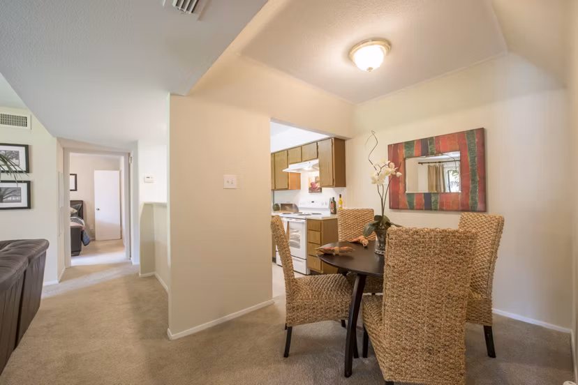 Dining area with elegant lighting and modern furniture at Huntcliff Apartments, showcasing luxury living in a welcoming atmosphere