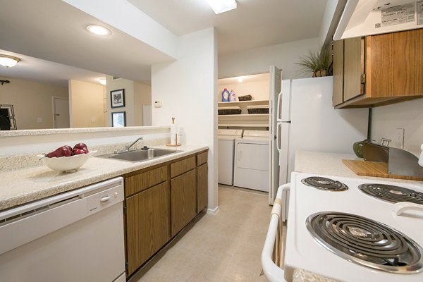 Modern kitchen featuring stainless steel appliances at Huntcliff Apartments