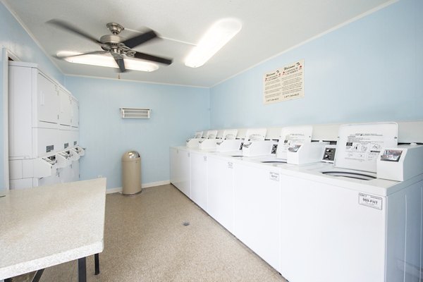 Laundry facility with modern washers and dryers at Huntcliff Apartments