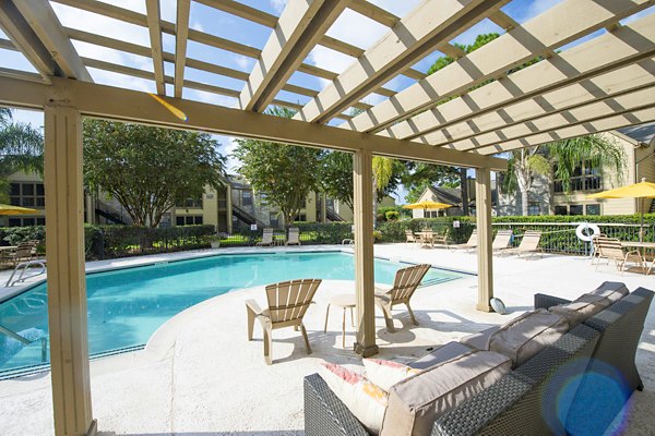 Expansive outdoor pool area at Huntcliff Apartments offering relaxation and scenic views