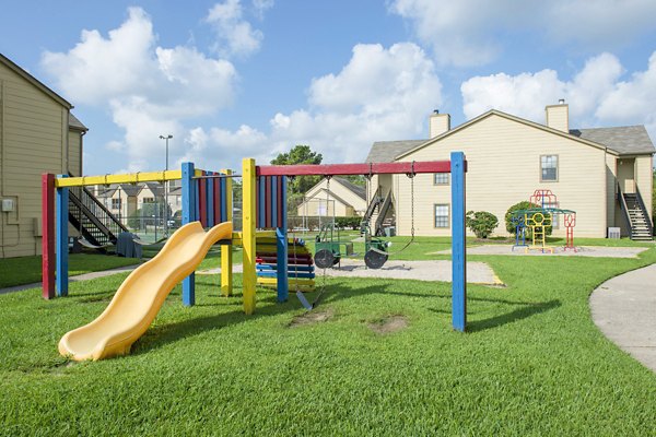 Modern playground with slides and swings at Huntcliff Apartments