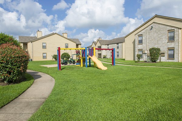 Playground with modern equipment at Huntcliff Apartments, offering family-friendly amenities in a vibrant community setting