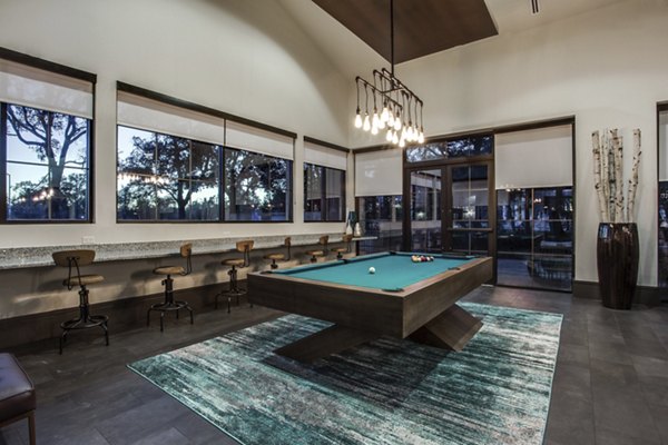 Contemporary game room with billiards and ample seating at The Michael at Presidio Apartments, offering luxury living in an engaging community space