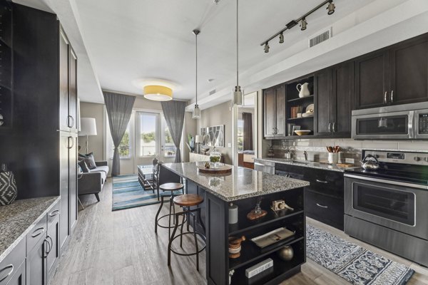 Modern kitchen with stainless steel appliances in The Michael at Presidio Apartments