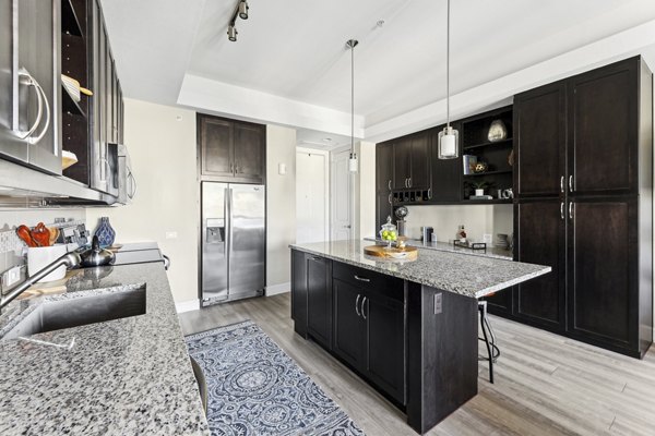 The Michael at Presidio: Modern kitchen with stainless steel appliances and granite countertops