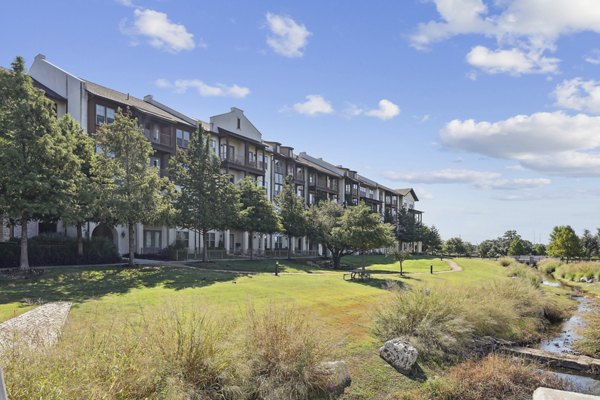 Recreational space with lounge chairs and greenery at The Michael at Presidio Apartments