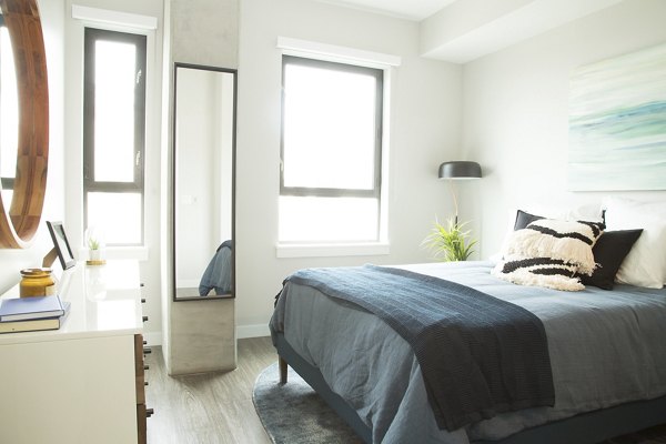 Cozy bedroom with plush bedding at Pierside South luxury apartments