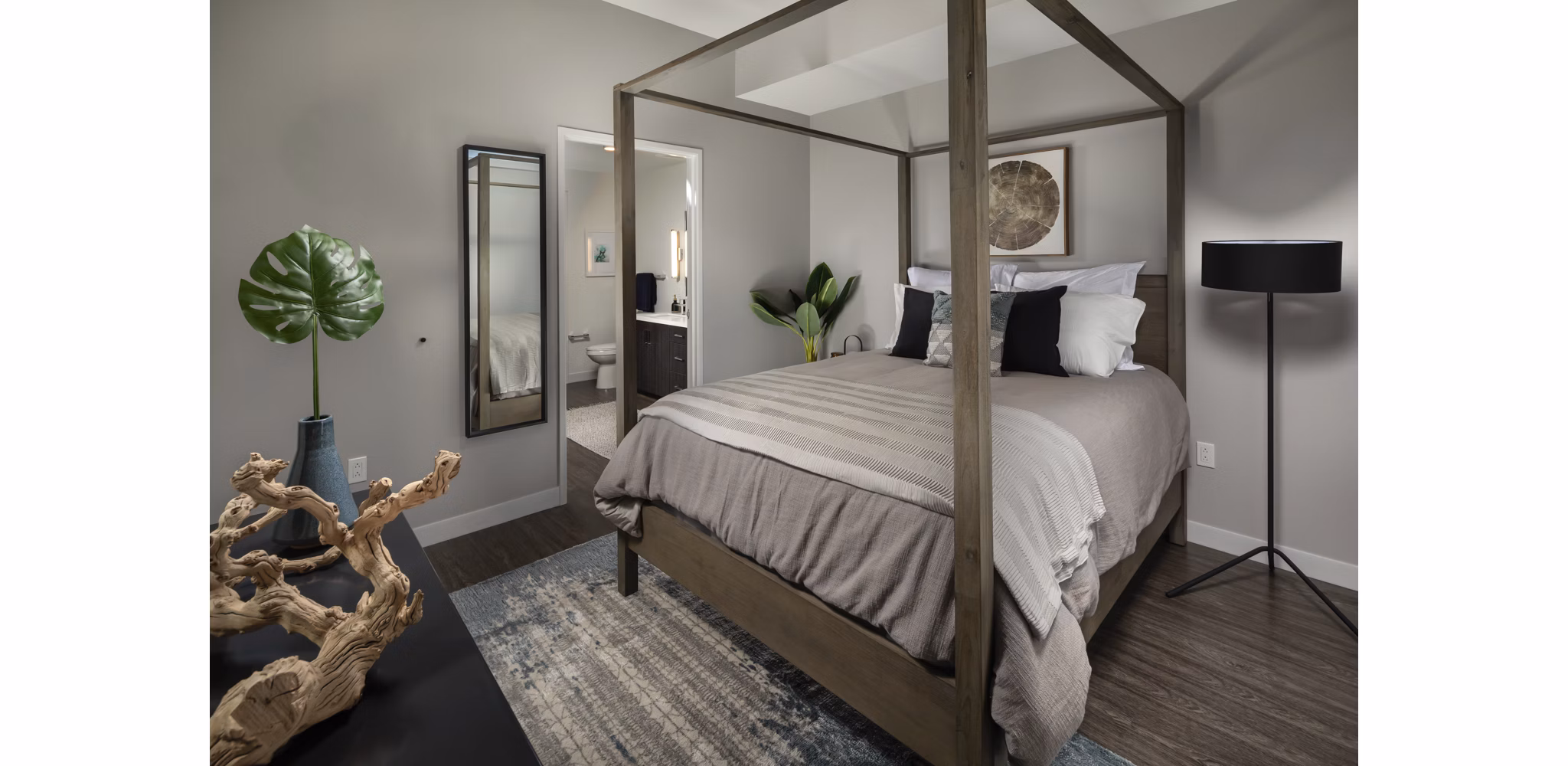 Spacious bedroom featuring modern decor and large windows at Pierside South Apartments, offering luxury living by the waterfront