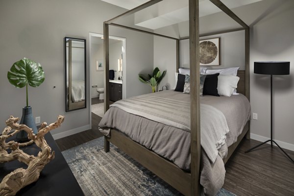 Spacious bedroom featuring modern decor and large windows at Pierside South Apartments, offering luxury living by the waterfront
