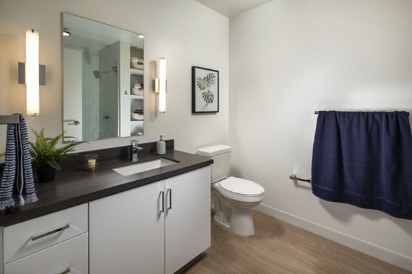 Bathroom with sleek fixtures and marble countertops at Pierside South Apartments