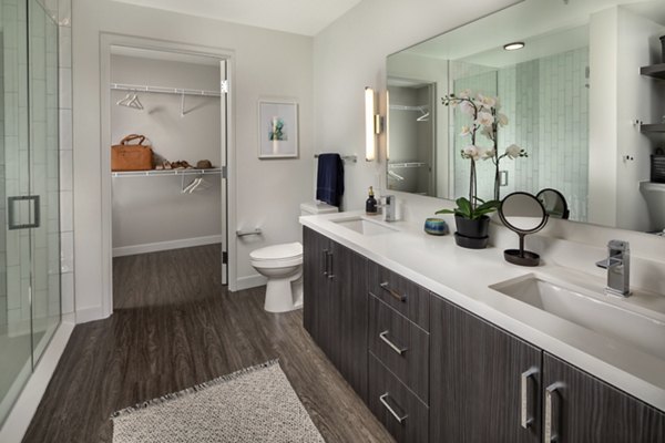 Pierside South Apartments: Modern bathroom with sleek fixtures and elegant lighting