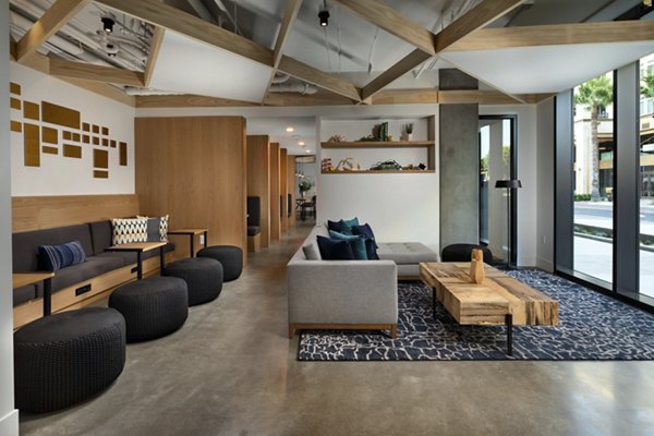 Pierside South Apartments: Stylish clubhouse with modern decor and seating areas near waterfront