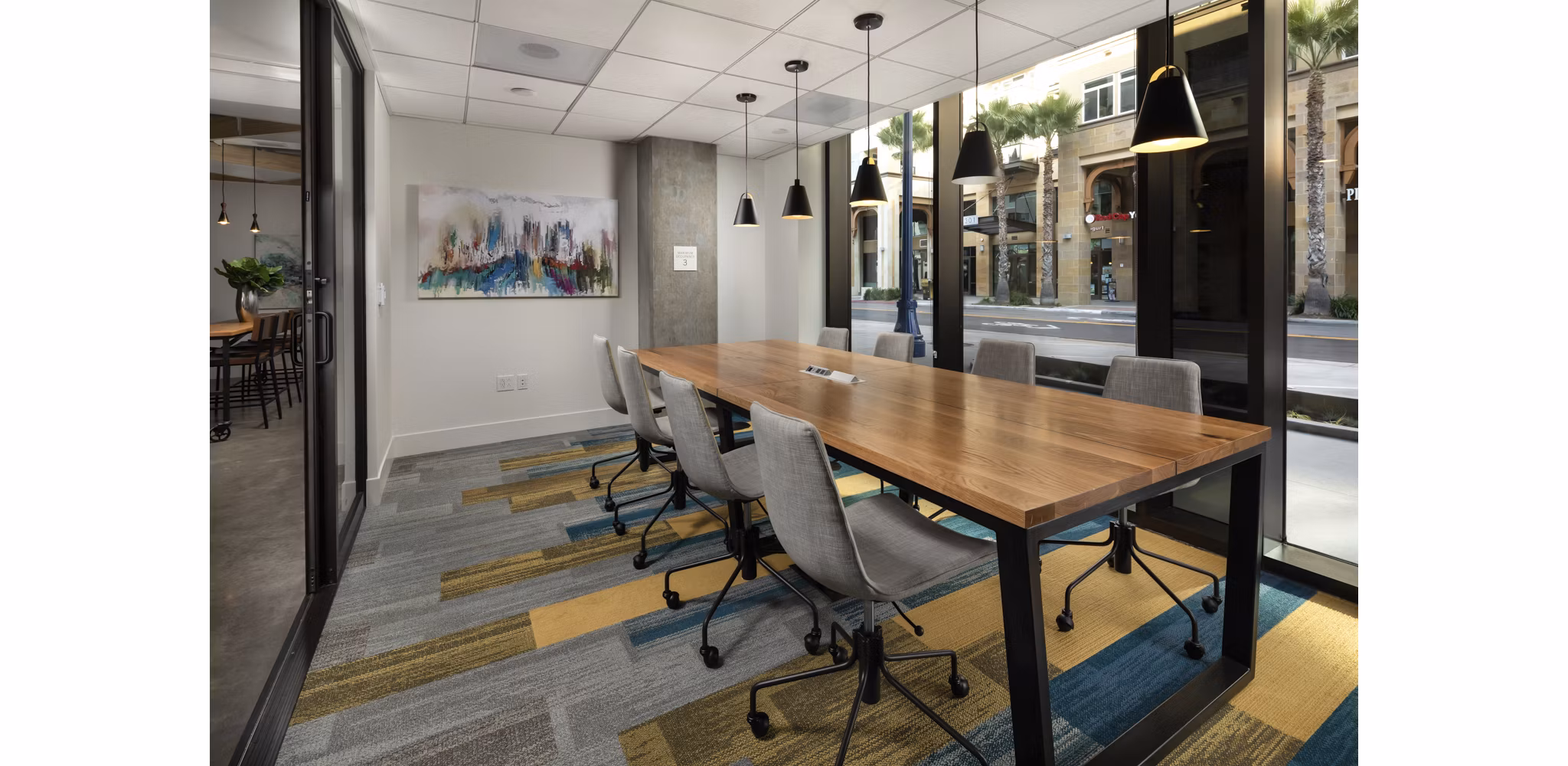 Modern meeting facility with large conference table at Pierside South Apartments featuring state-of-the-art technology and comfortable seating
